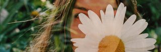 Woman hiding behind a flower outside